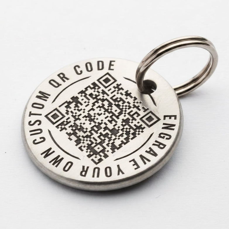 Silver pet tag with QR code and engraving text on a white background