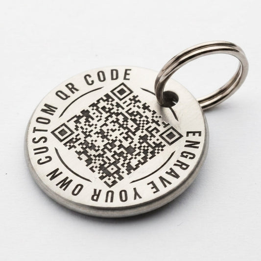 Silver pet tag with QR code and engraving text on a white background
